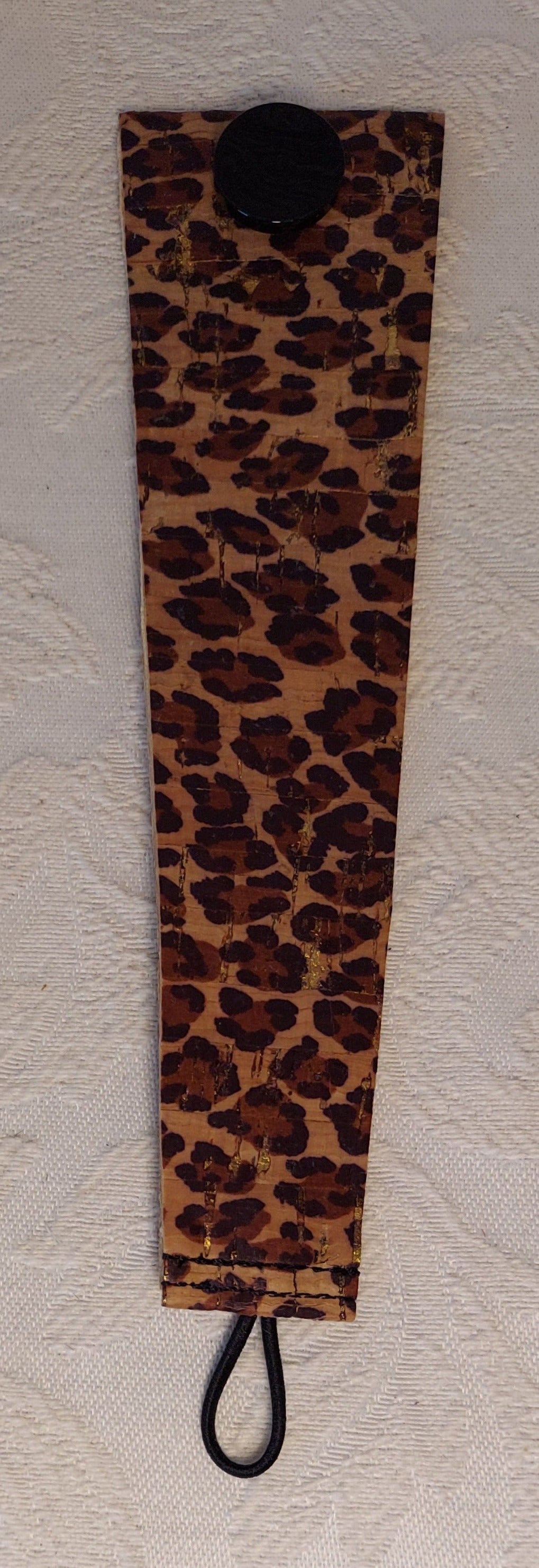 Flat view of leopard-themed cork bracelet featuring exotic leopard print and earthy cork texture for a bold accessory.