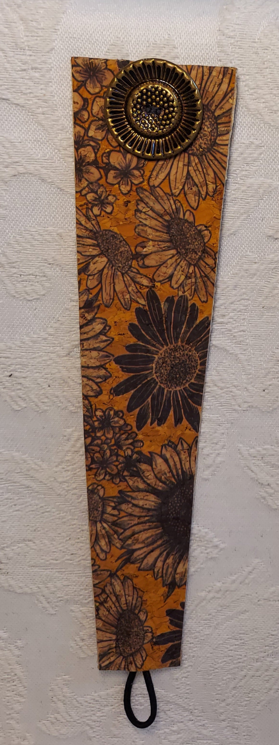 Flat view of the Sunflower Cork Bracelet showcasing detailed sunflower designs on sustainable cork, perfect for eco-conscious fashion.