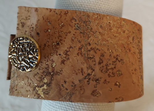 Gold-flecked natural cork bracelet with a textured gold button clasp, showcasing eco-friendly design and chic style.